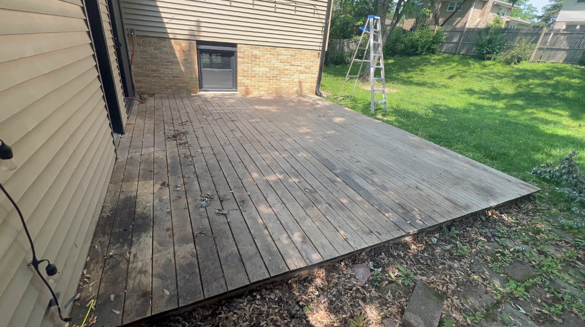 Weathered backyard wood patio before protective color staining