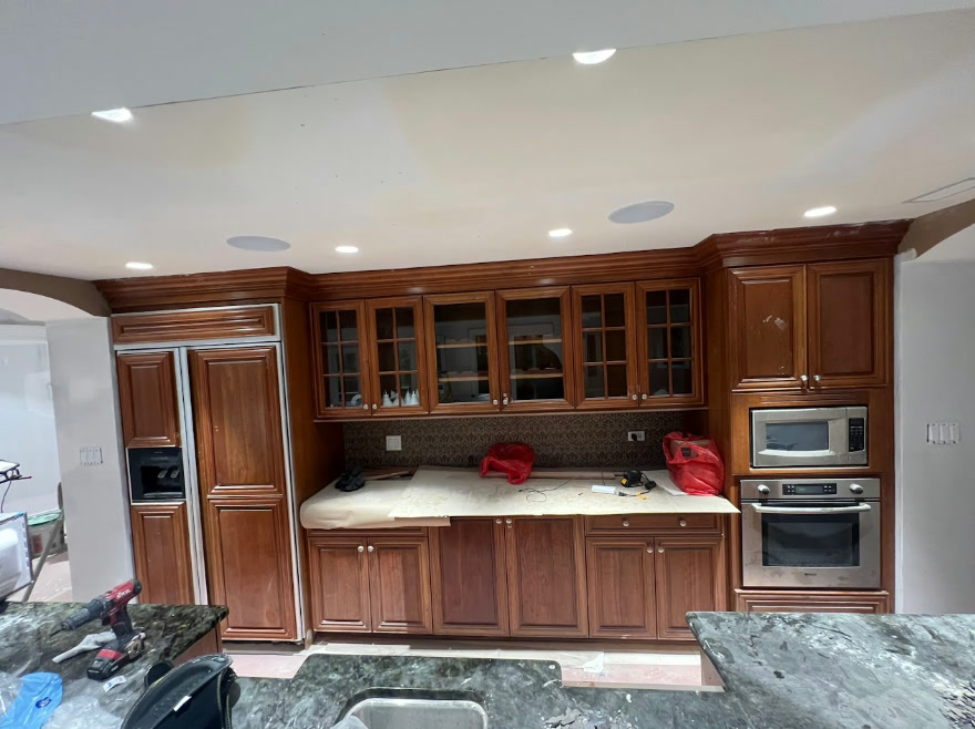Careful kitchen cabinet surface preparation and taping before painting