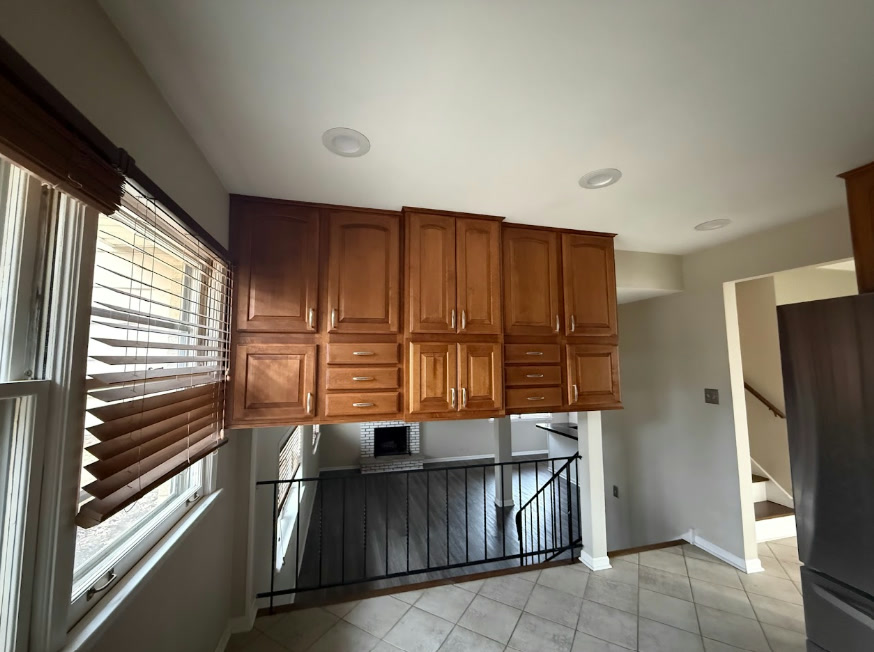 Dated stained brown wood upper kitchen cabinets before painting