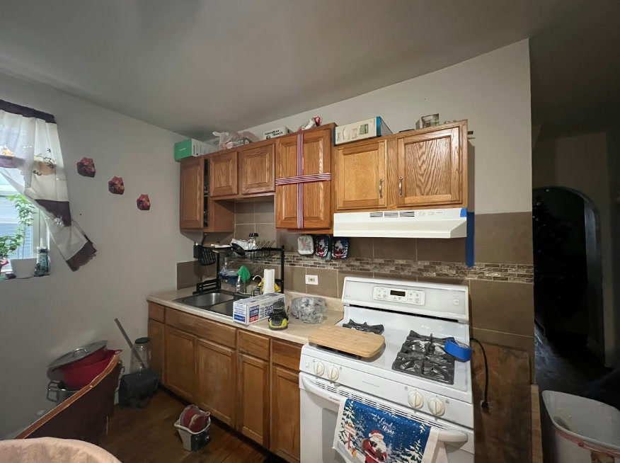 Kitchen cabinets with original wood finish before painting